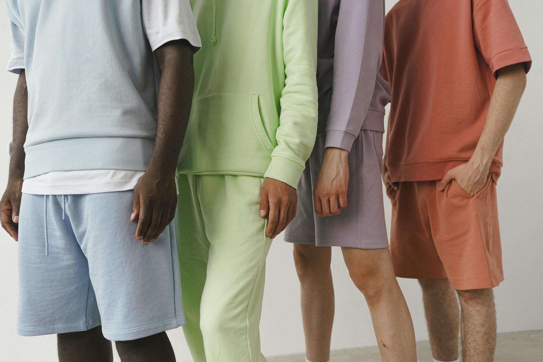 models wearing sweatshirts and shorts in variety of colours